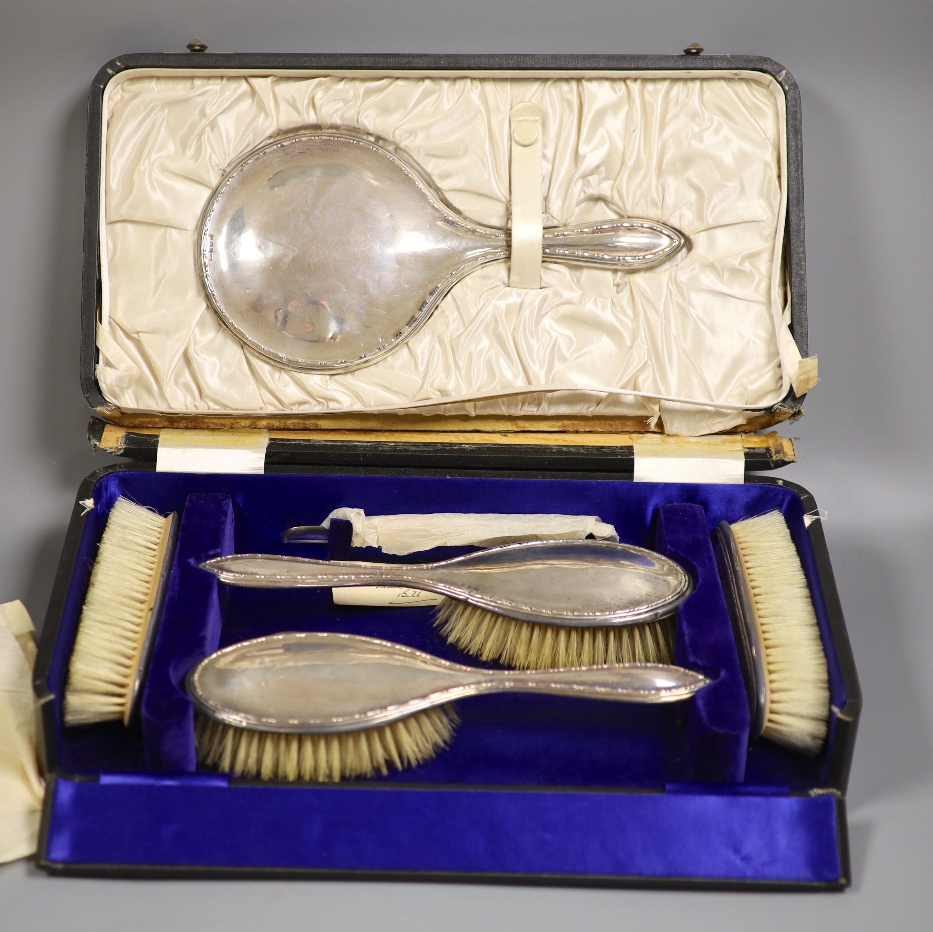 A cased George V six piece mirror and brush set.